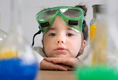 Young child wearing green safety goggles