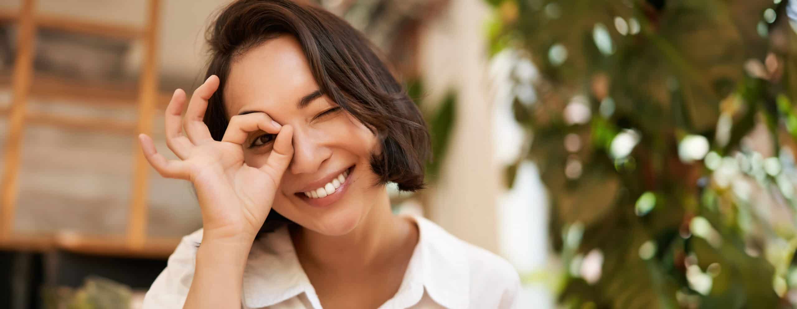 Smiling woman making an okay sign