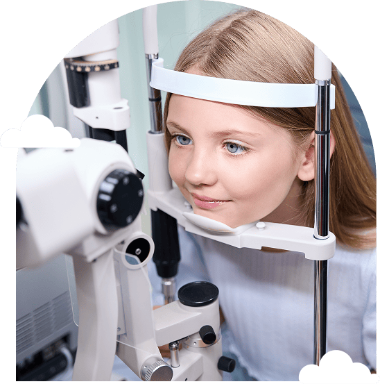 a-girl-at-an-eye-exam-smiling-while-using-a-slit-lamp-in-an-optometrist's-office