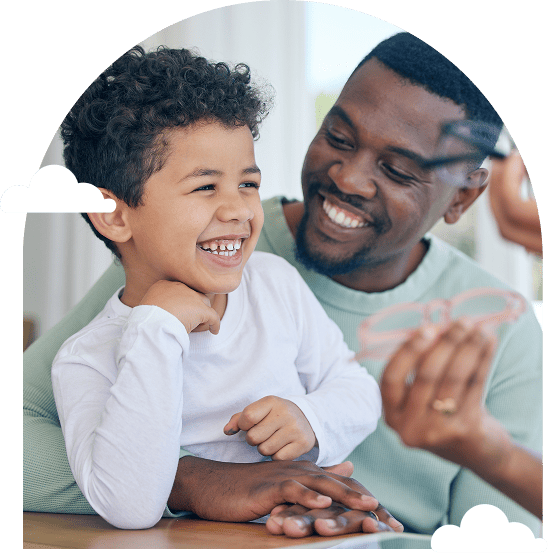 father-and-son-laughing-together-at-a-table-surrounded