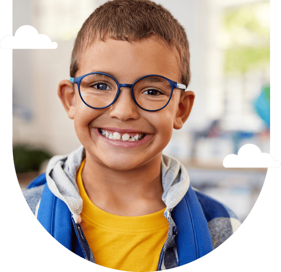 smiling-boy-with-glasses-and-blue-backpack-in-a-classroom